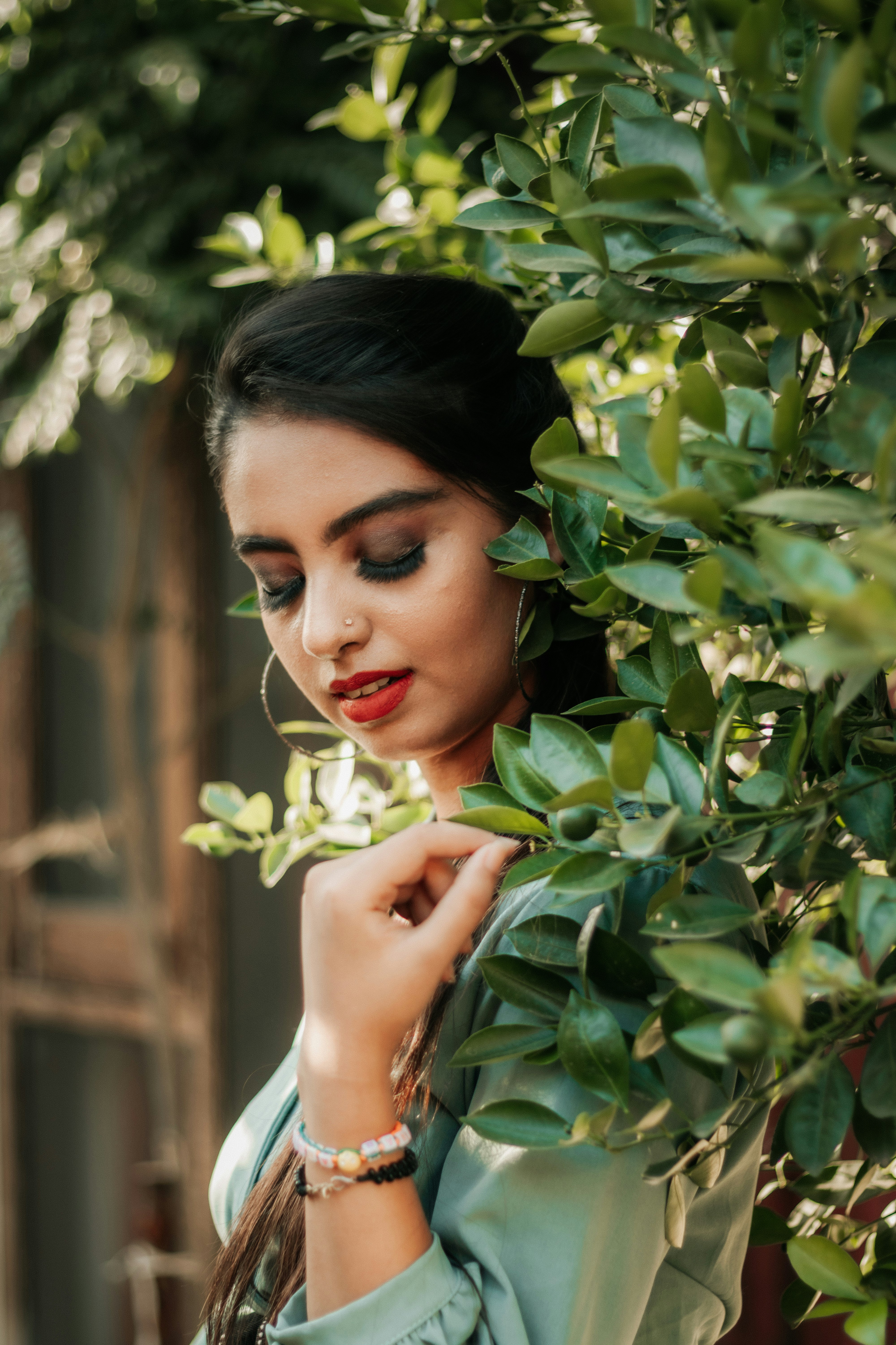 woman in white dress holding green leaves